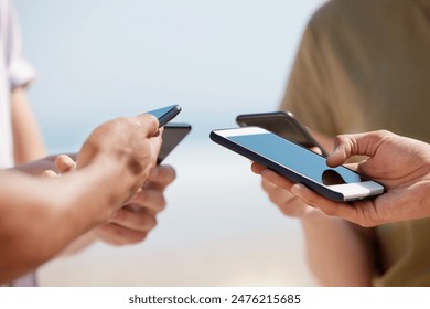 Hands, smartphone and group of people for connection, network and communication as gen z in outdoor. Friends, mobile technology and sharing for social media, internet and digital footprint in circle - Powered by Shutterstock