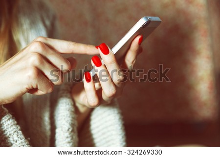 hands with smartphone touching screen and using app