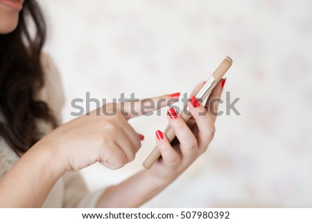 hands with smartphone touching screen and using app