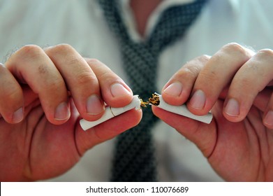 Hands Of A Smoking Addict Adult Man Breaking A Cigarette To Half Quitting Smoking.No Smoking Concept. Copy Space