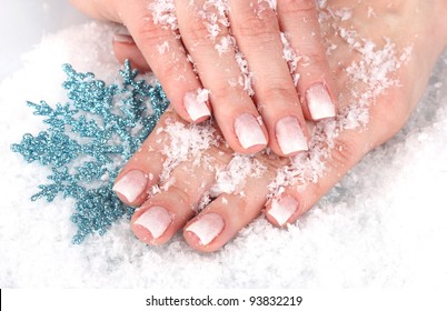 hands with snow and snowflake closeup