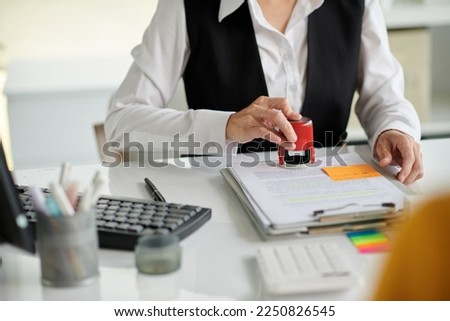 Hands of social worker setting seal on document Foto stock © 