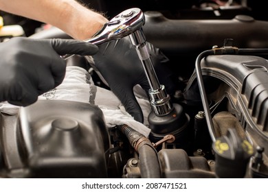 Hands With Socket Wrench Ratchet. Changing Car Oil Filter. DIY Change Engine Motor Oil. At Home Vehicle Maintenance. Filter Replacement. Oil Filter Cap