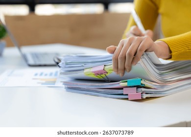 Hands Sorting Through Paperwork on Desk