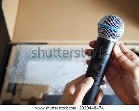 Hands of sound technician holding and assembling wireless microphone cartridge or capsule, equipment set up for live streaming or live performance. Enjoy Music and Entertainment. (selective focus) Stock photo © 