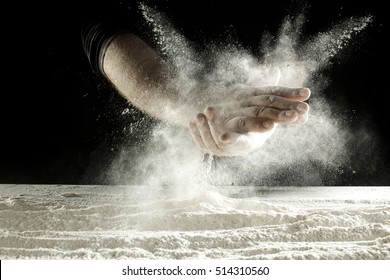 Hands With Splash Of White Flour And Black Background 