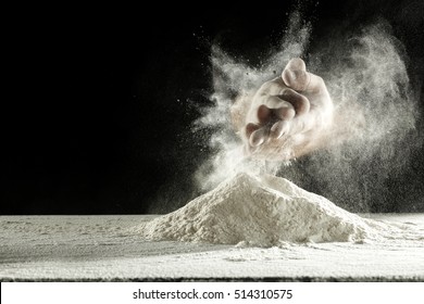 Hands With Splash Of White Flour And Black Background 