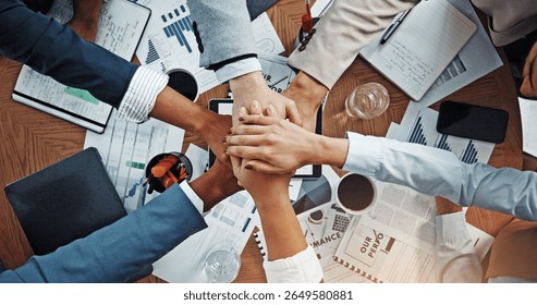 Hands, stack and above at meeting with documents, finance, support and team work at office. Business people, group and circle with link, motivation or synergy with celebration for revenue at company