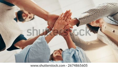 Hands, stack and team at office with low angle, support or synergy with goals in circle at startup. People, group and huddle at workplace for celebration, success or collaboration at creative agency