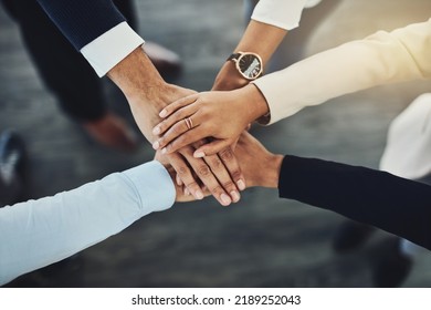 Hands Stacked Or Piled To Show Team Unity, Strength Or Motivation Among Business Men, Women Or Colleagues From Above. Closeup Of Huddled, Motivated Group Of Businesspeople In Support And Trust