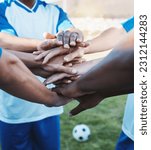 Hands stacked, sports and men on a soccer field for support, motivation and team spirit. Goal, training and athlete football players with a gesture for celebration, solidarity and trust at a game