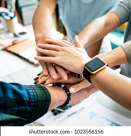 Hands stacking support each other