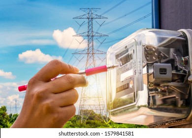 The Hands Of Staff Are Checking The Electricity Meter For Home Electrical Appliances.