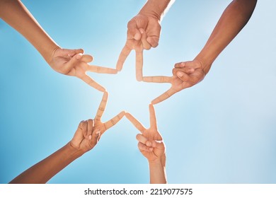 Hands, Star And Teamwork With Friends In A Huddle On A Clear Blue Sky Background From Below. Trust, Support And Community With A Group Of People Making A Hand Sign Shape Outdoor Together In The Day