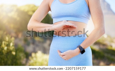 Hands, stomach and diet with a sports woman training, exercising or losing weight for good gut health and fitness. Exercise, workout and weightloss with a healthy female athlete framing her belly