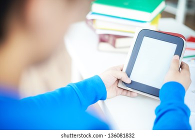 Hands of students holding and using touchpad