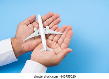 hands support airplane model, travel insurance concept.