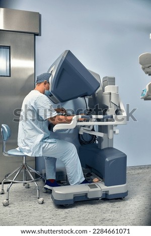 Hands of a surgeon at a computer robot. medical robot. Robotic Surgery.