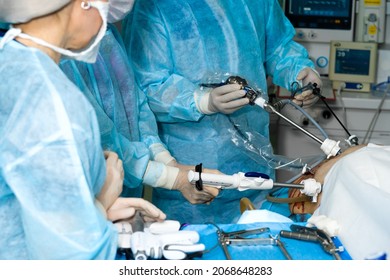 Hands of surgeons with laparoscopic surgical manipulators. Selective accent. Minimally invasive laparoscopic surgery using special instruments. Surgical treatment of proctological diseases.