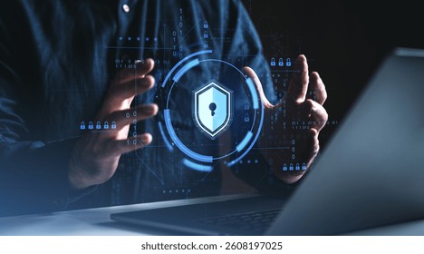 Hands surrounding a glowing digital padlock icon with binary code overlay, symbolizing cybersecurity concept on dark background