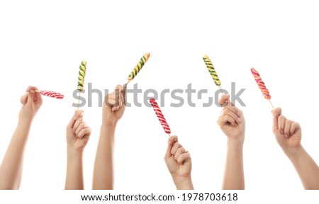 Hands with sweet lollipops on white background