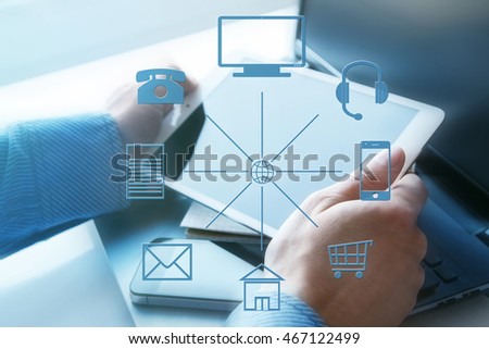 Hands with a tablet and different icons around. Omni channel 