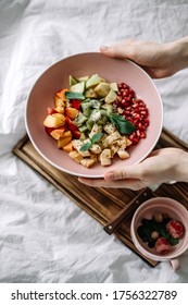 Hands Taking Fresh Fruits On A Pink Bowl. Healthy Food, Breakfast In Bed.