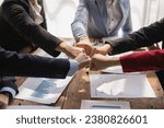 The hands of a team of businessmen joining forces celebrate the concept of unity. A close-up photo of a team working together to make business successful. teamwork business