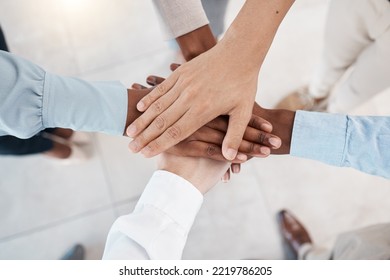 Hands, Teamwork And Motivation With Business People Standing In A Huddle Or Circle Together From Above. Office, Meeting And Solidarity With A Man And Woman Employee Group Joined In Unity Or Trust