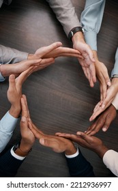 Hands, Teamwork And Synergy With Business People In A Circle Or Huddle As A Team On A Wooden Table In The Office. Collaboration, Motivation And Goal With An Employee Group Working Together On Success