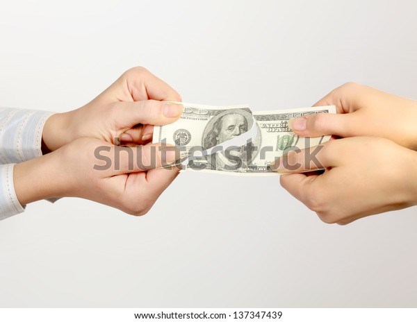 Hands tear money\
isolated on white\
background