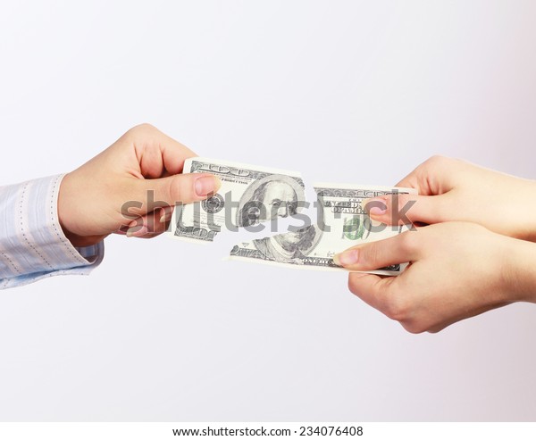 Hands tear money\
isolated on white\
background