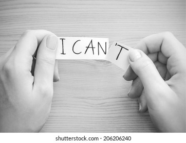 Hands tear a paper with text "I can't" - Powered by Shutterstock