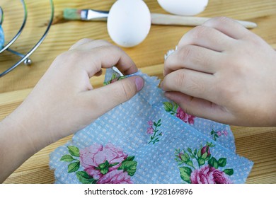 Hands Tearing The Egg Decorating Napkin. Decorating Easter Eggs With Decoupage Technique. Step By Step, Tutorial. Step 2