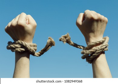 Hands Tearing Shackles The Background Of Blue Sky. Concept Of Freedom