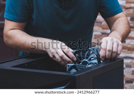 Hands of technician installs computer cooling element. Close up cleaning the pc cooler. Upgrade or PC assembly concept. Hardware components and technology background.