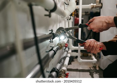 Hands Of Technician Or Plumber Repairing Broken Pipes In Toilet