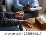 Hands of teenage boy drinking water when talking to his psychologist about bipolar disorder