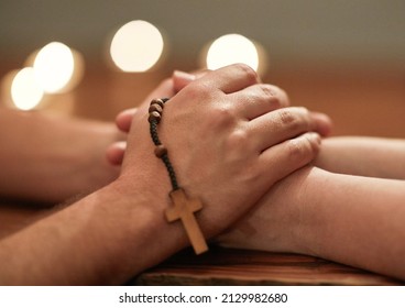 Hands are there to help others. Cropped shot of two people holding hands and praying together.