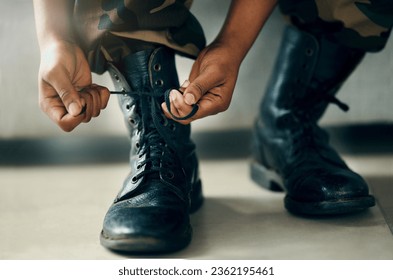 Hands tie shoes, closeup and soldier in army getting ready to start war, battle or fight. Boots, man tying laces in military and veteran preparing gear for training, exercise and workout to travel - Powered by Shutterstock