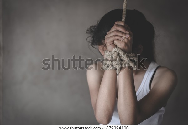 Hands tied up with rope of a missing kidnapped,\
 Victims of the human trafficking.  Abused and tortured concept.\
Stop violence against Women. International women\'s Day. Stop\
abusing violence.