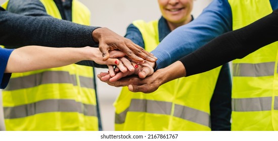 hands together of multiracial people, teamwork engineers in factory, workers hands together in warehouse - Powered by Shutterstock