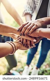 Hands, together and stack for team building with people outdoor, support and solidarity in nature. Community, mission and partnership, trust and commitment with loyalty, group huddle and agreement