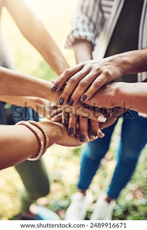 Hands, together and stack for team building with people outdoor, support and solidarity in nature. Community, mission and partnership, trust and commitment with loyalty, group huddle and agreement