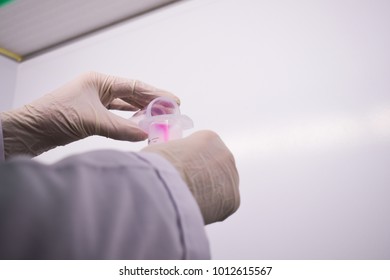 Hands transferring test samples to tubes