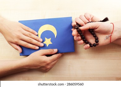 Hands Of Two Friends With Different Religions Symbols