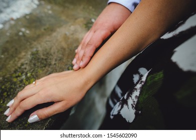 Hands Of Two Lovers. A Man Holds The Girl By The Hand, Close-up. Goosebumps