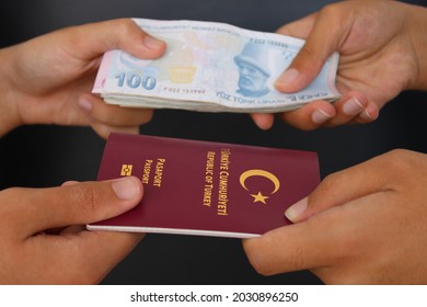 The Hands Of Two Men Holding Turkish Passports.. Buying A Passport For Money. Fake Passport.