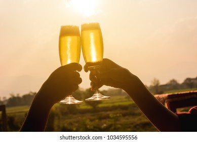 Hands Of Two People Toast Champange Celebrating Under Afternoon Sunlight, Celebrating Occation