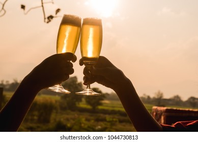 Hands Of Two People Toast Champange Celebrating Under Afternoon Sunlight, Celebrating Occation